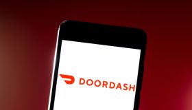 In this photo illustration the DoorDash logo is seen...