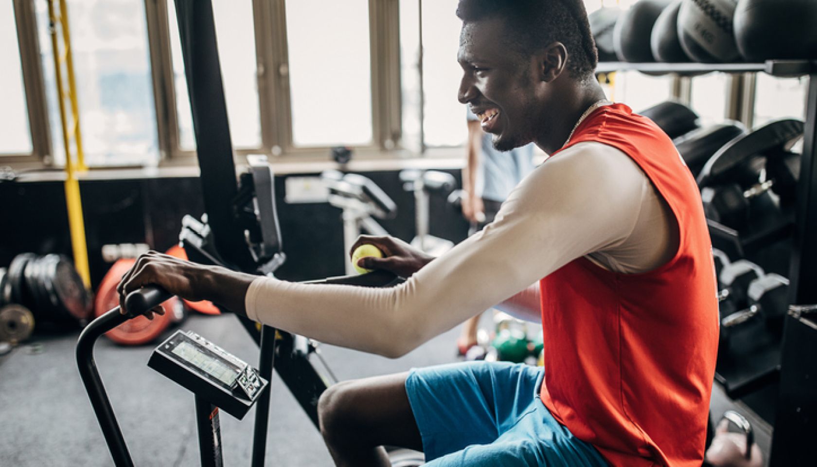 One young man volleyball player training on exercise bike