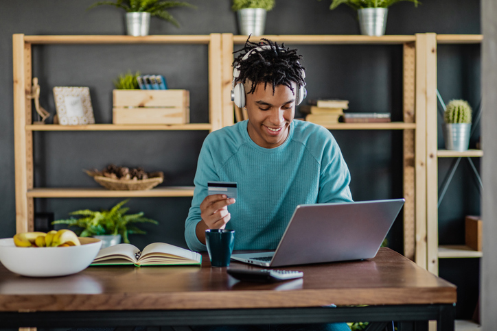 Young African American man is shopping from home