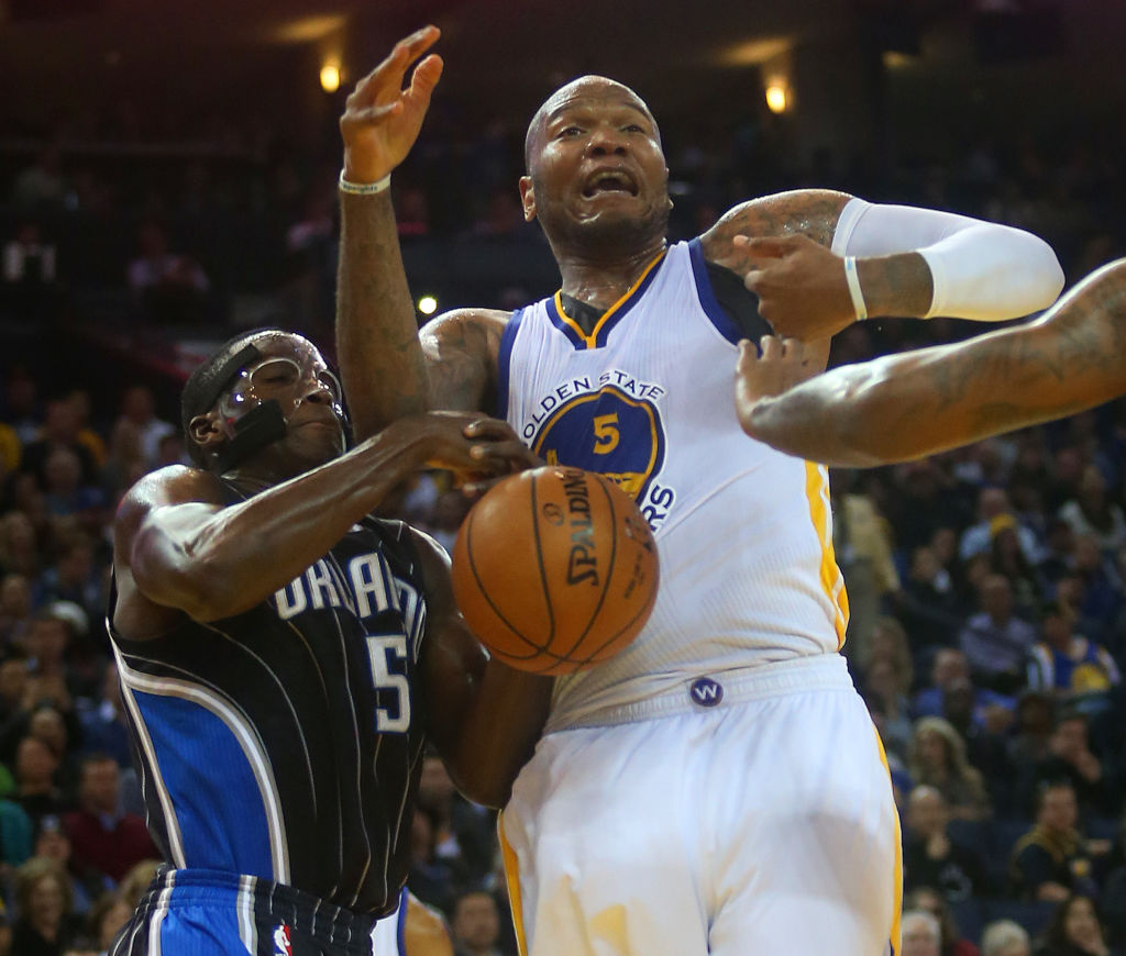 Golden State Warriors forward Marreese Speights (5) battles the Orlando Magic's Victor Oladipo (5) for a loose ball during their game on Tuesday, Dec. 2, 2014 in Oakland, Calif. (Aric Crabb/Bay Area News Group)