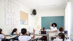 Teacher teaching in classroom respecting social distancing between students