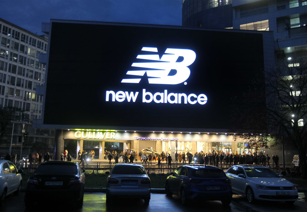 A huge screen shows the logo New balance an American sports...
