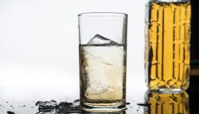 selective focus drink alcohol and water glass with whisky and Sparking water and ice cube