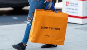 A shopper carries a Louis Vuitton shopping bag on Londons...