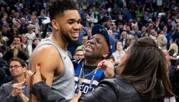 Timberwolves player Karl Anthony Towns hugs his parents after a game.