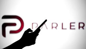 In this photo illustration a Parler logo is seen behind a...