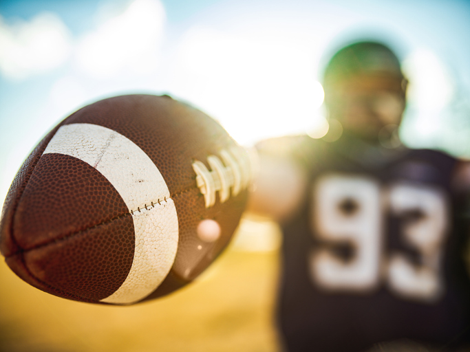 Football in the hands during game