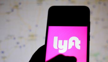 In this photo illustration the Lyft logo is seen displayed...