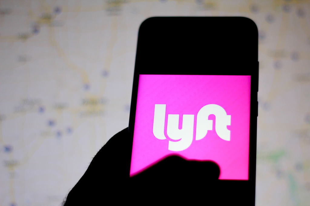 In this photo illustration the Lyft logo is seen displayed...