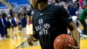 A Colorado Rams basketball player warms up wearing a Black...