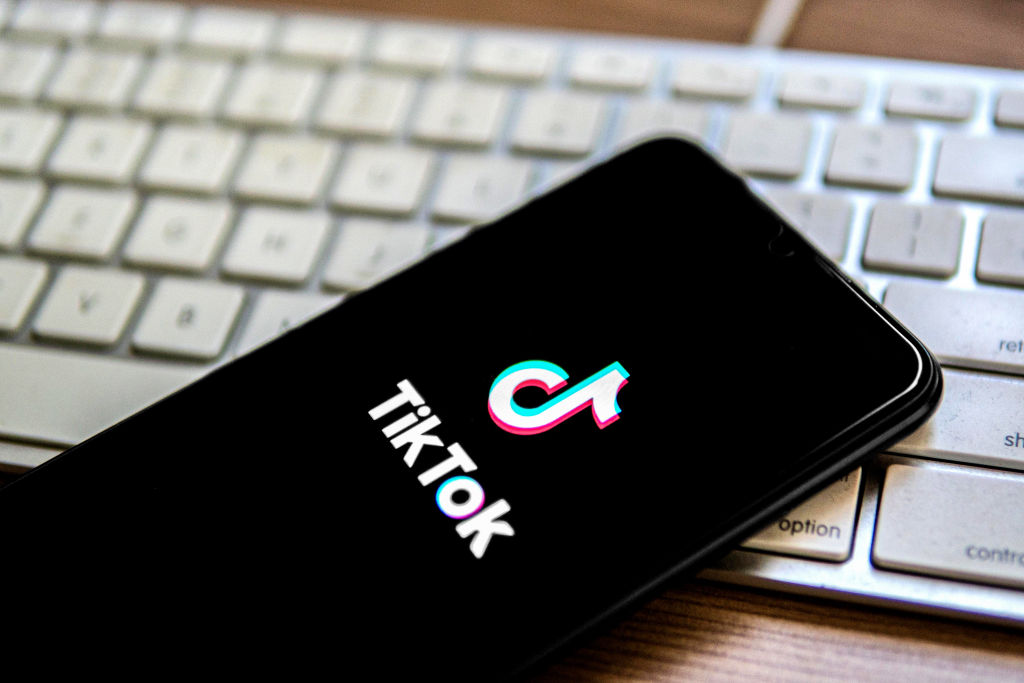 In this photo illustration, a TikTok logo seen displayed on...