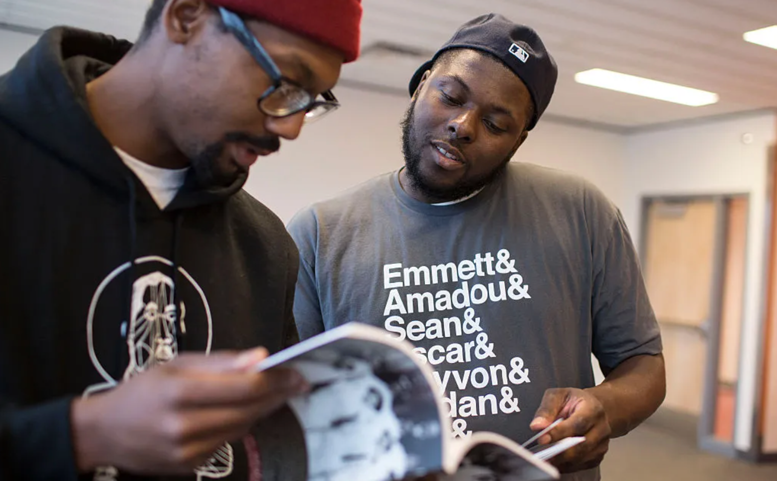 Tory Russell (right) and Damon Davies (left) look through books offered at a “Books and Breakfast” event on Saturday, Jan. 31, 2015, at the Ferguson Community Center in Ferguson, Missouri. The Washington Post / Getty
