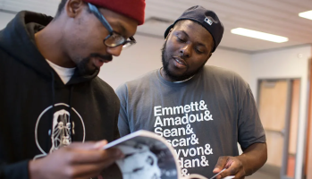 Tory Russell (right) and Damon Davies (left) look through books offered at a “Books and Breakfast” event on Saturday, Jan. 31, 2015, at the Ferguson Community Center in Ferguson, Missouri. The Washington Post / Getty