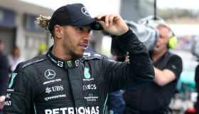 Lewis Hamilton of Mercedes AMG Petronas F1 Team looks on at...