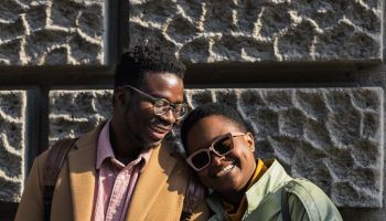 Young attractive black woman leaning her head on boyfriend’s shoulder - valentine's day