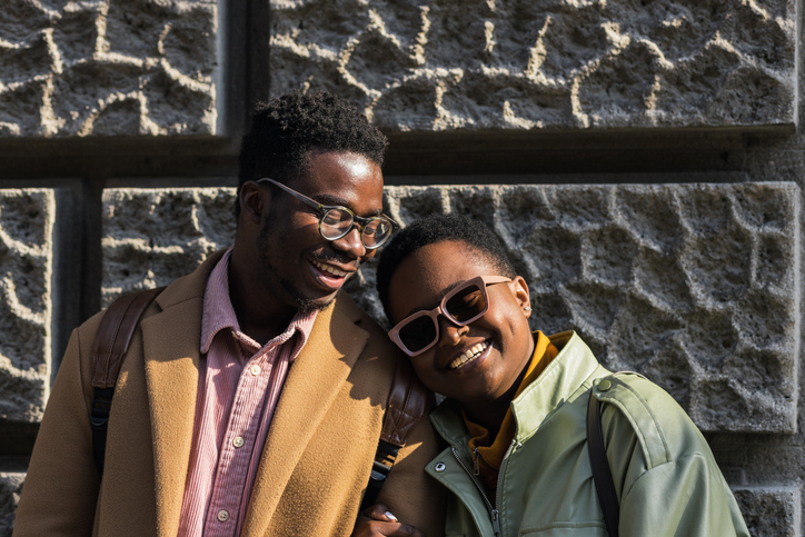 Young attractive black woman leaning her head on boyfriend’s shoulder - valentine's day