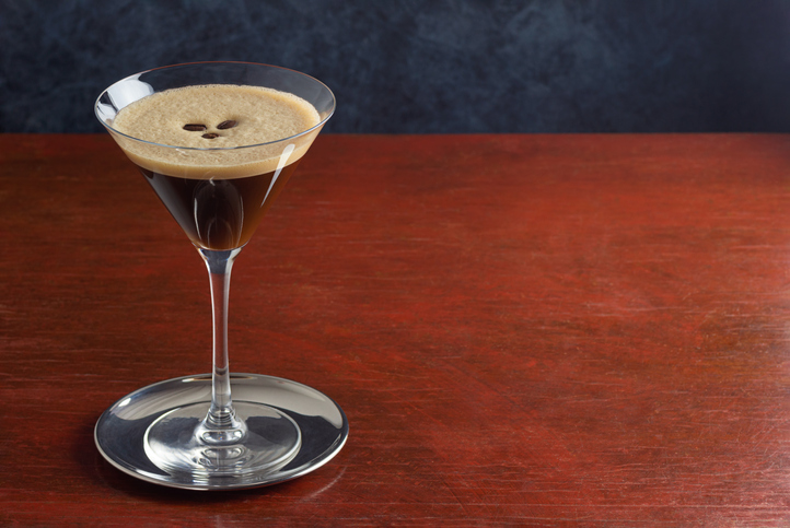 Espresso Martini Made From Vodka, Espresso, and Coffee Liqueur in a Martini Glass on a Wooden Table