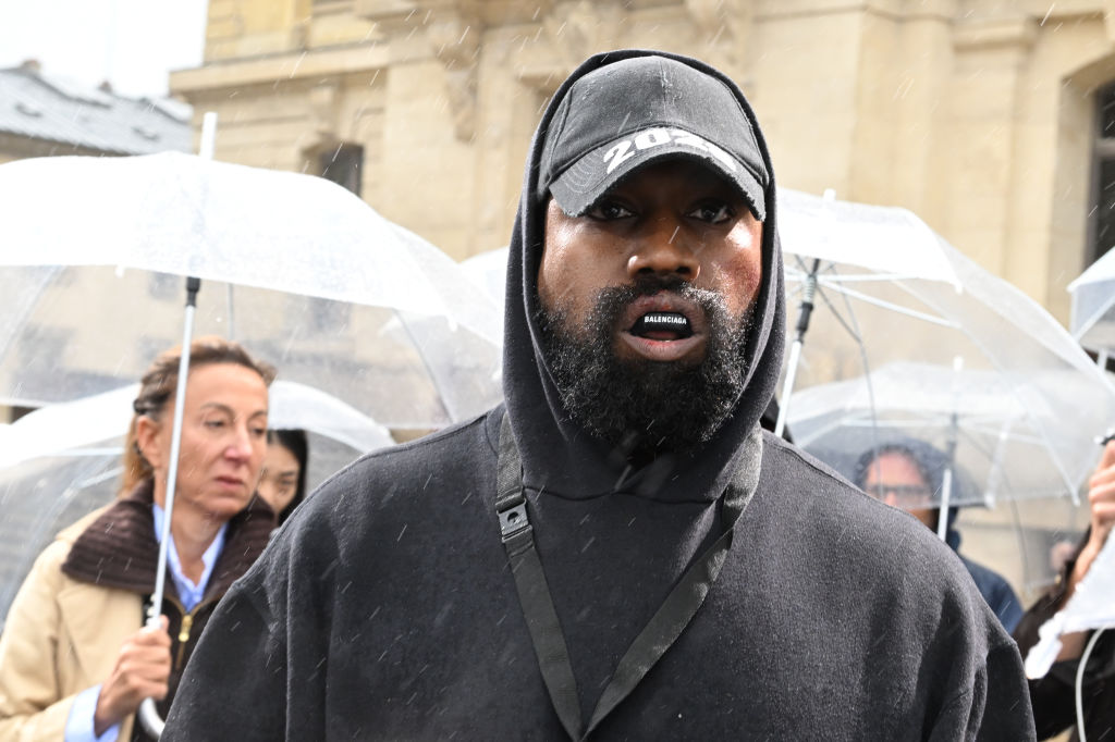 Kanye West leaving his office in a red and blue checkered jacket