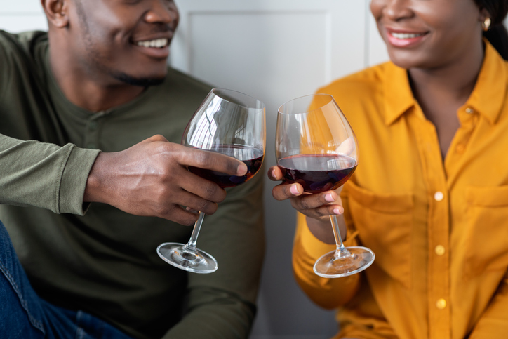 Toast For Us. Closeup Of Black Couple Clinking Glasses With Red Wine