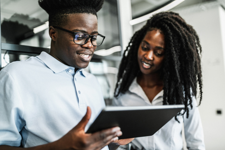 Two young people discussing a project in modern office