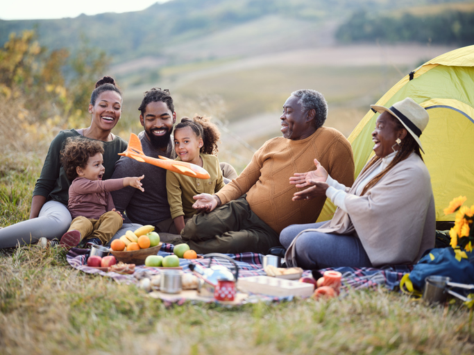 Happy black extended family having fun on camping in nature.