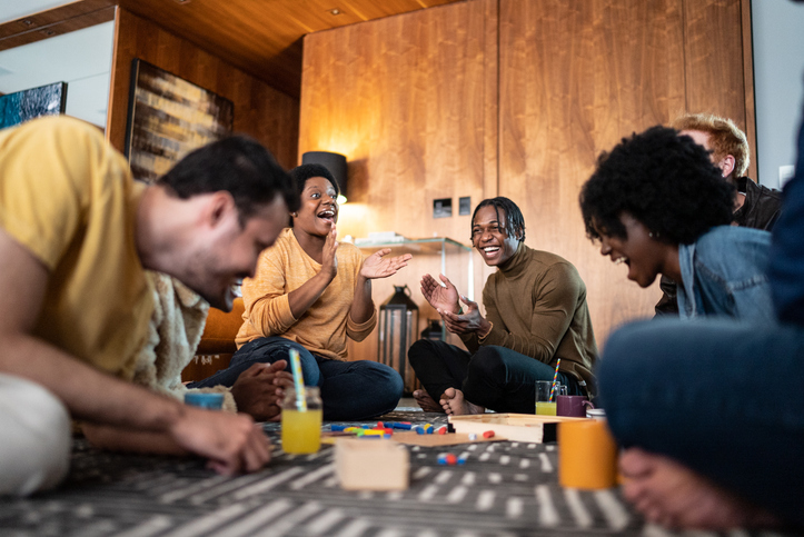 Friends playing board game at home