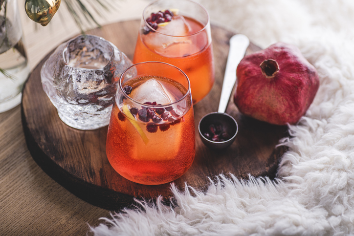 Winter and New Year's cocktail with freshly squeezed pomegranate juice and pomegranate seeds. Winter healthy vitamin cocktails for the blood, superfood. Cozy holiday atmosphere