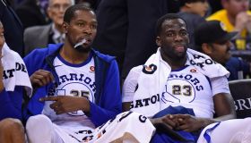 Golden State Warriors' Kevin Durant (35) and Golden State Warriors' Draymond Green (23) sit on the bench during the final minute of the fourth quarter of their NBA game against the Charlotte Hornets at Oracle Arena in Oakland, Calif. on Friday, Dec. 29, 2