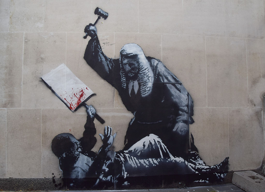 The latest artwork by elusive street artist Banksy appears, Banksy, Royal Courts of Justice, London, mural