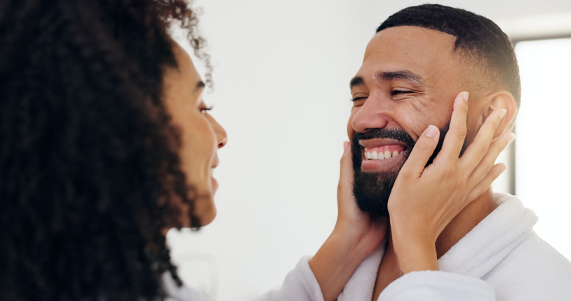 Bathroom, smile and touching face with couple in home together for bonding, love or morning routine. Facial, satisfaction and skincare with happy people in apartment for beauty, grooming or hygiene
