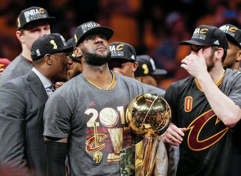 Cleveland Cavaliers' LeBron James holds the the Larry O’Brien NBA Championship Trophy after defeating Golden State Warriors 93 to 89 in Game 7 of the NBA Finals at Oracle Arena on Sunday, June 19, 2016 in Oakland, Calif