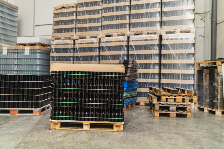 Storing beer bottles on pallets in a brewery warehouse