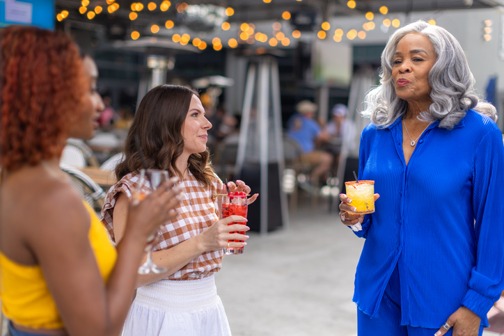 Mature Woman with her Daughter and Daughter-In-Law Holding Cocktails at Las Vegas Rooftop Pub