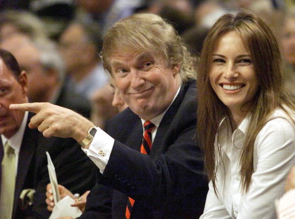 New York Knicks fan Donald Trump (L) sits in the f