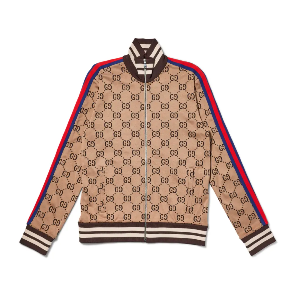 A beige and brown patterned jacket with red and blue stripes on the sleeves and collar, featuring the Gucci logo.