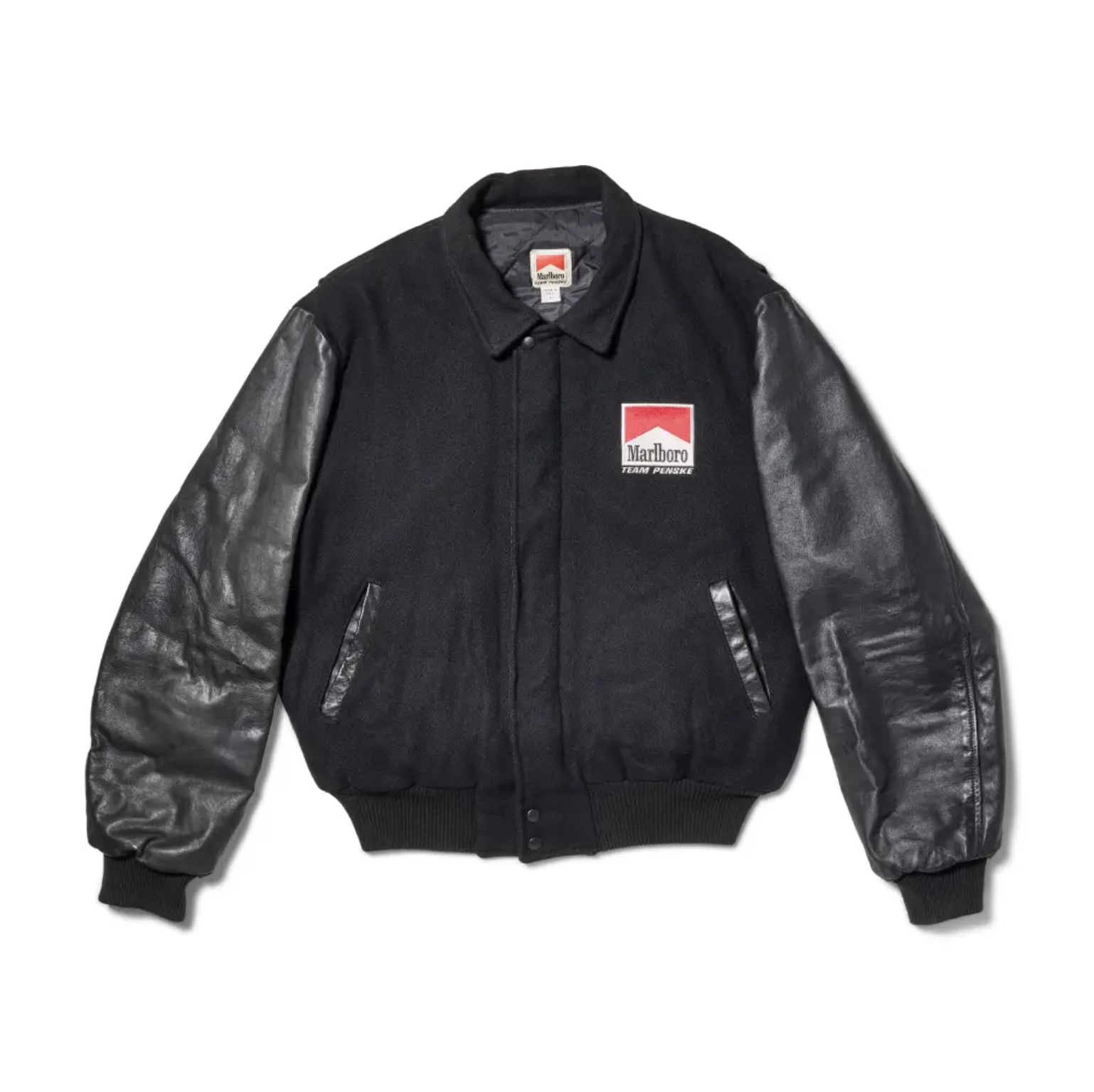 Black jacket with Marlboro logo on the chest and leather sleeves.