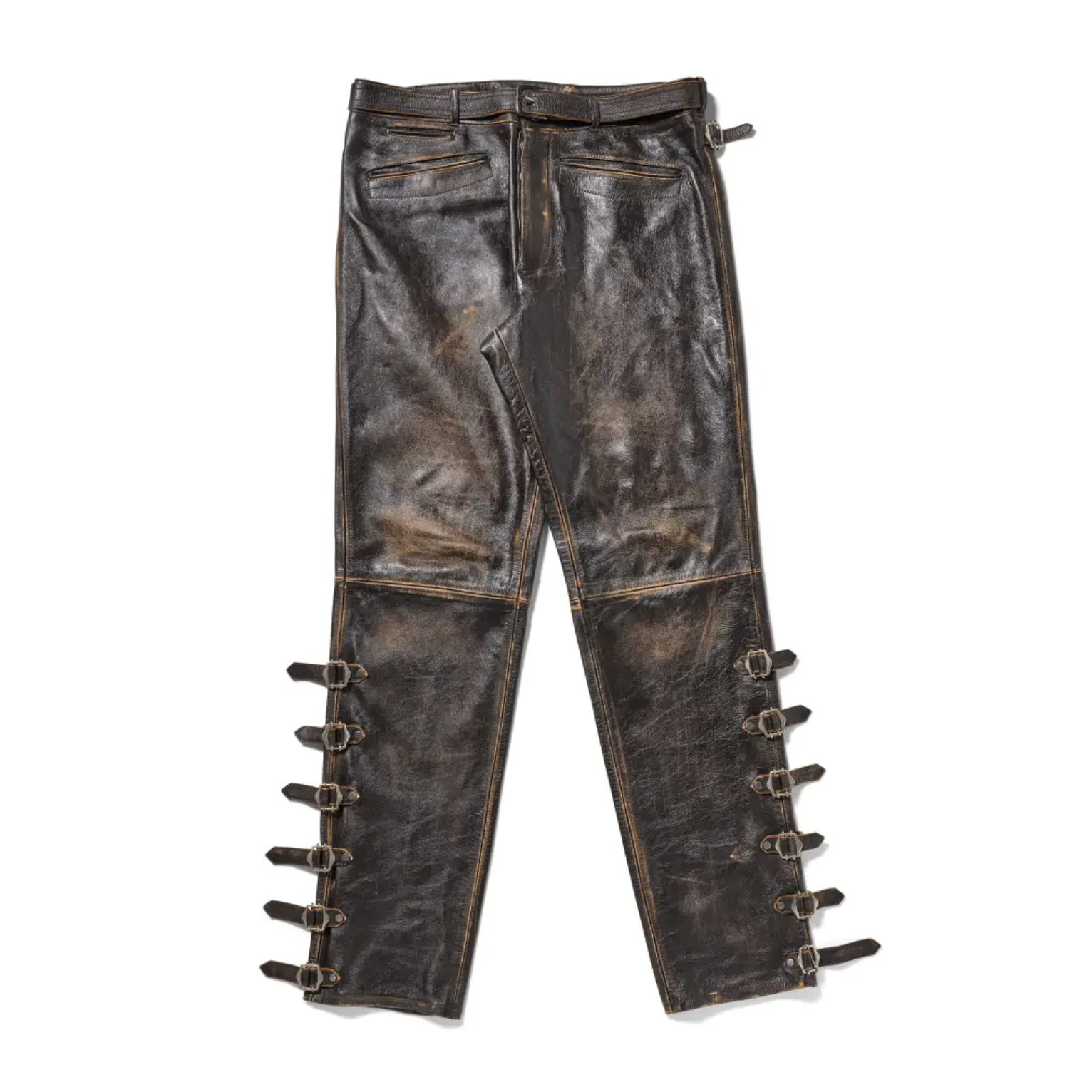 Worn leather pants with multiple buckle straps and distressed detailing.