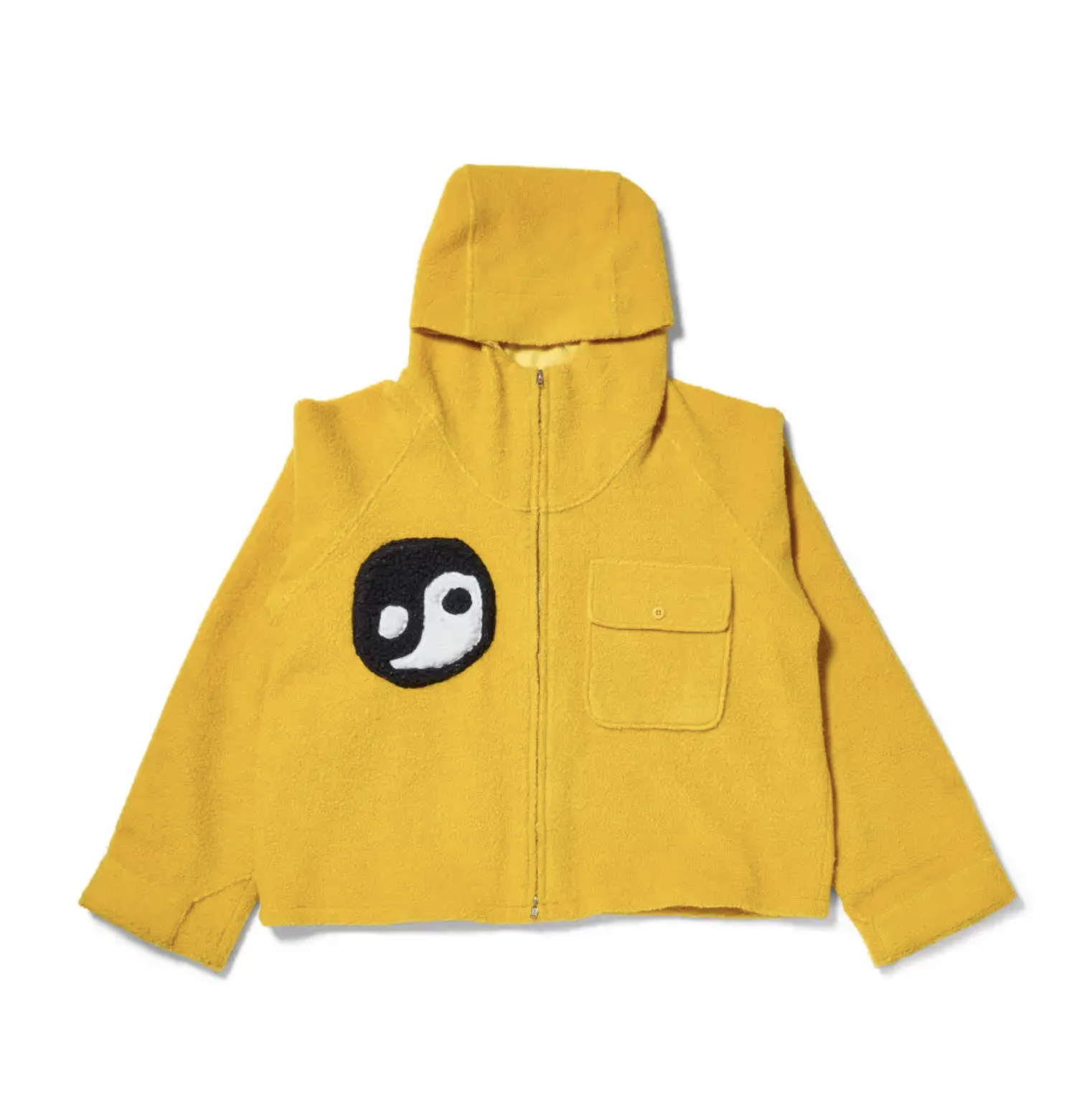 A yellow hooded jacket with a black and white yin-yang symbol printed on the front.