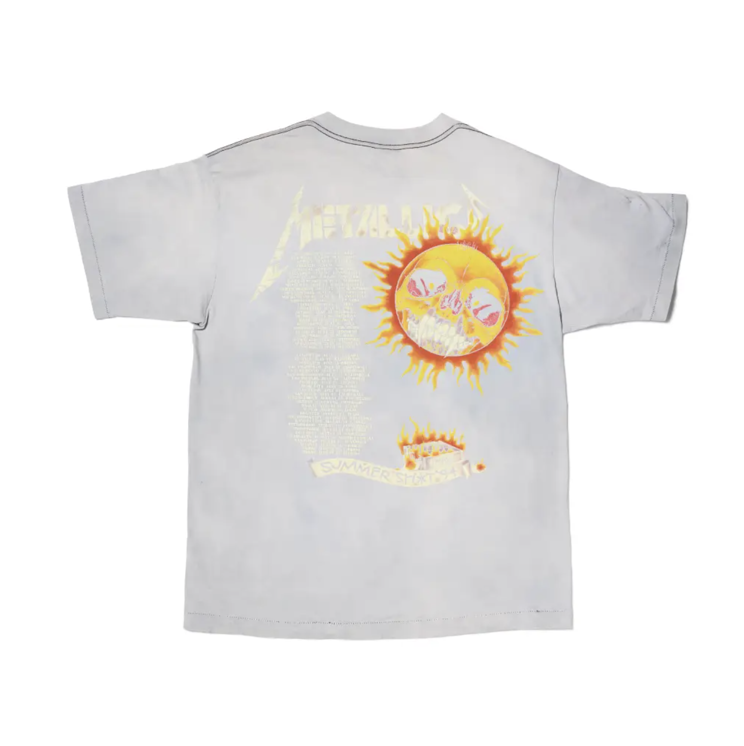 A white t-shirt with a graphic design featuring a sun with a skull face and the text "The Texas Chainsaw Massacre".