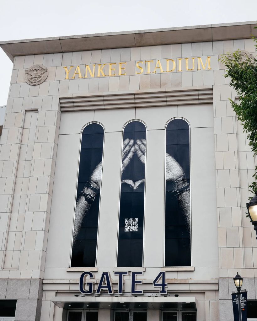 Exterior of Yankee Stadium with the stadium name and Gate 4 entrance visible.