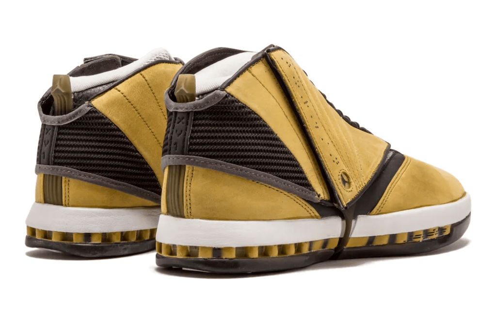 A pair of yellow and black sneakers with a textured upper and white soles.