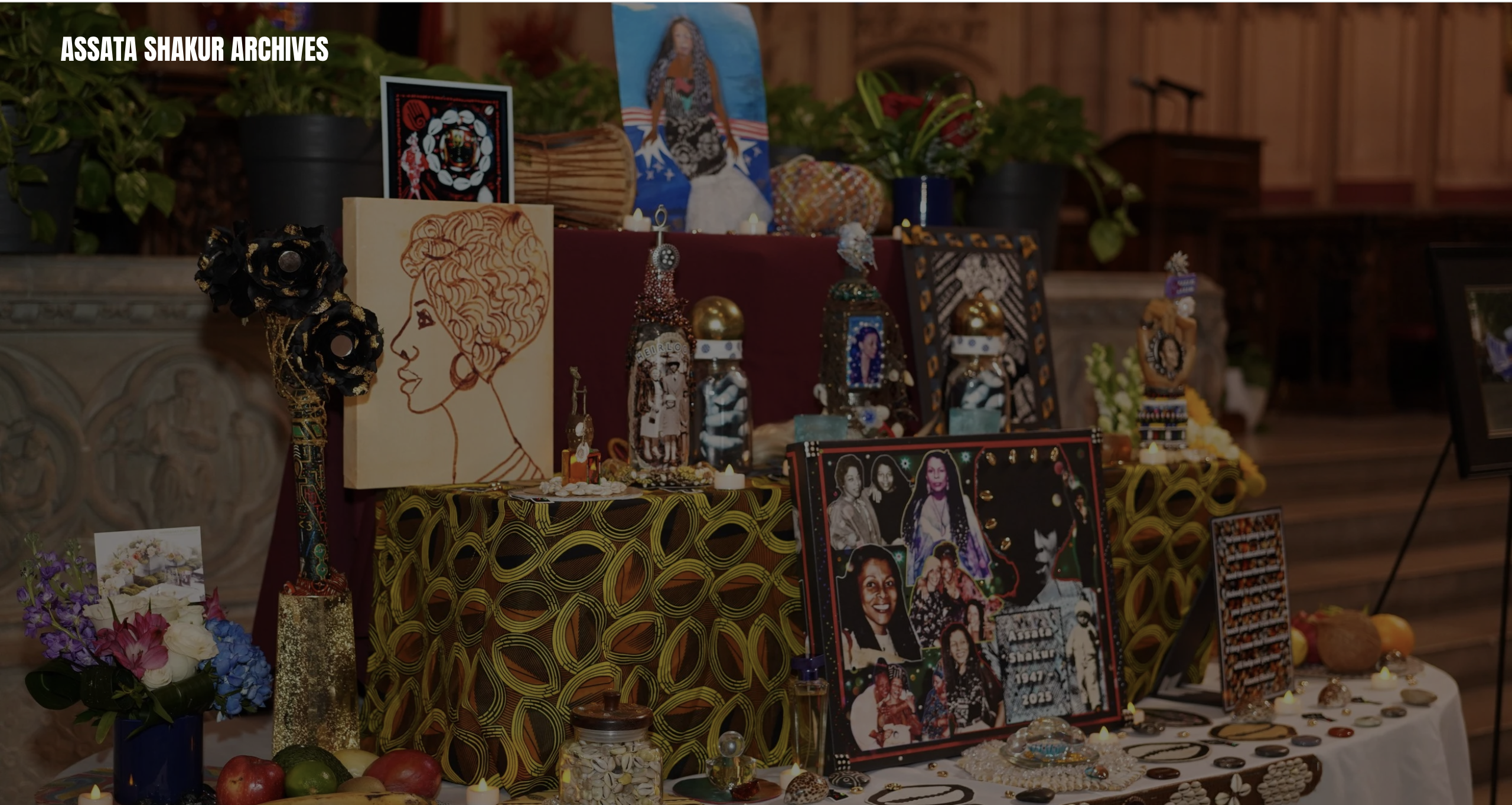 A display of framed artwork, photographs, and memorabilia honoring Assata Shakur, an activist and former member of the Black Panther Party.