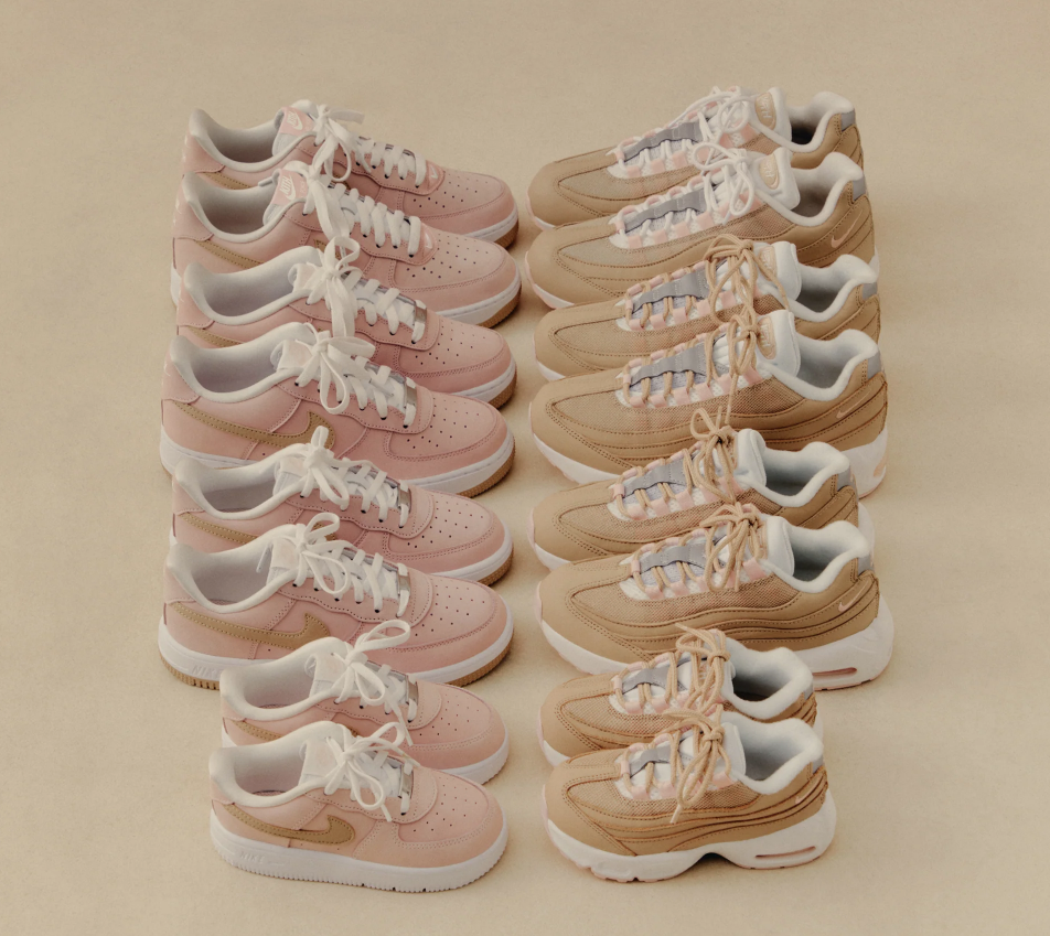 Multiple pairs of pink and beige athletic shoes arranged in rows on a beige background.