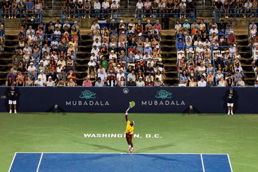 A large crowd fills the stadium stands at the Mubadala Citi DC Open tennis tournament in Washington, D.C., watching a player on the court.
