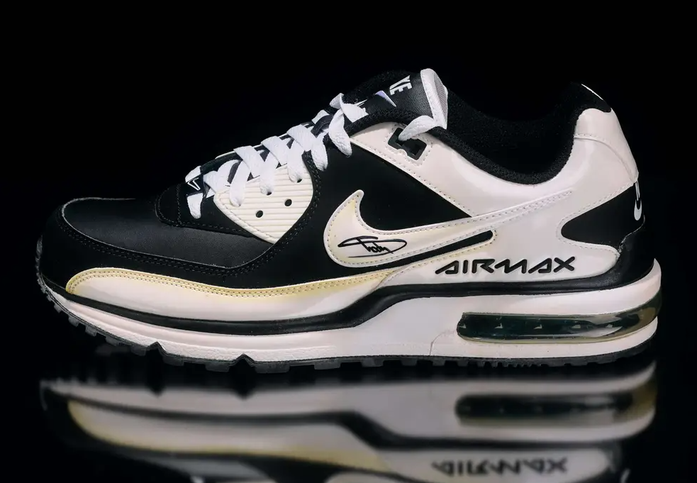 Black and white Nike Air Max sneakers with reflective details