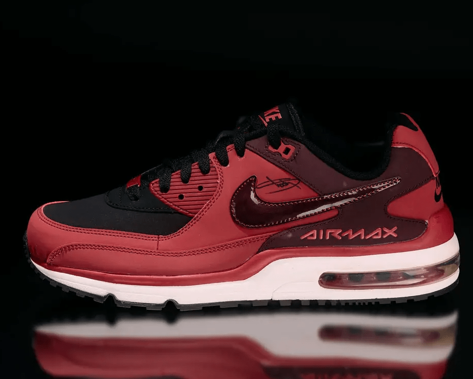 A pair of red and black Nike Air Max sneakers with the Air Max branding visible.