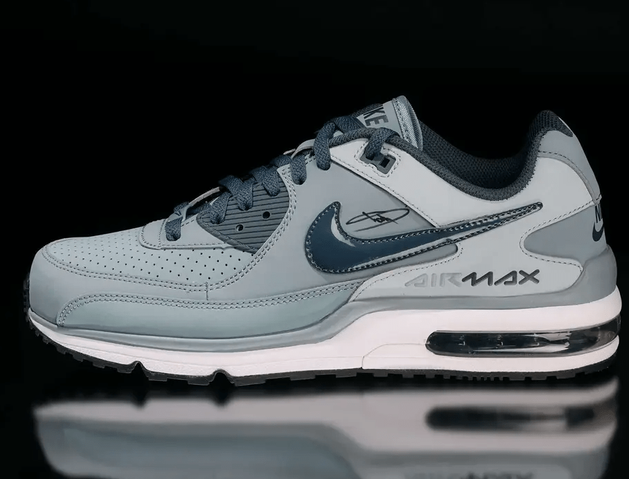 A pair of gray and black Nike Air Max sneakers with visible air cushioning technology and branding.