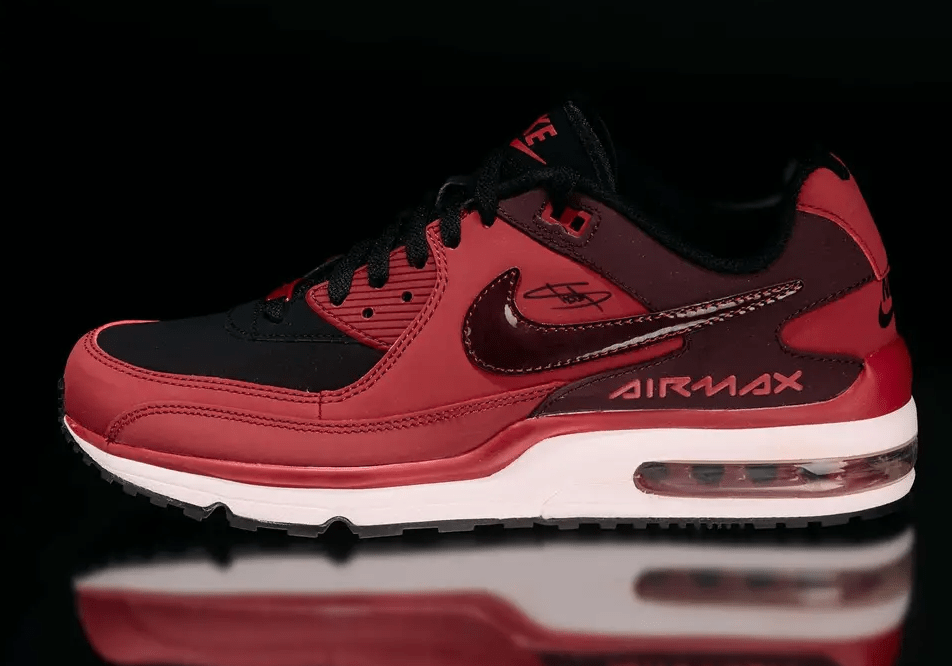 A pair of red and black Nike Air Max sneakers with the Air Max branding visible.