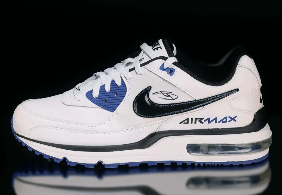 White and blue Nike Air Max sneakers with black accents and "Air Max" branding.