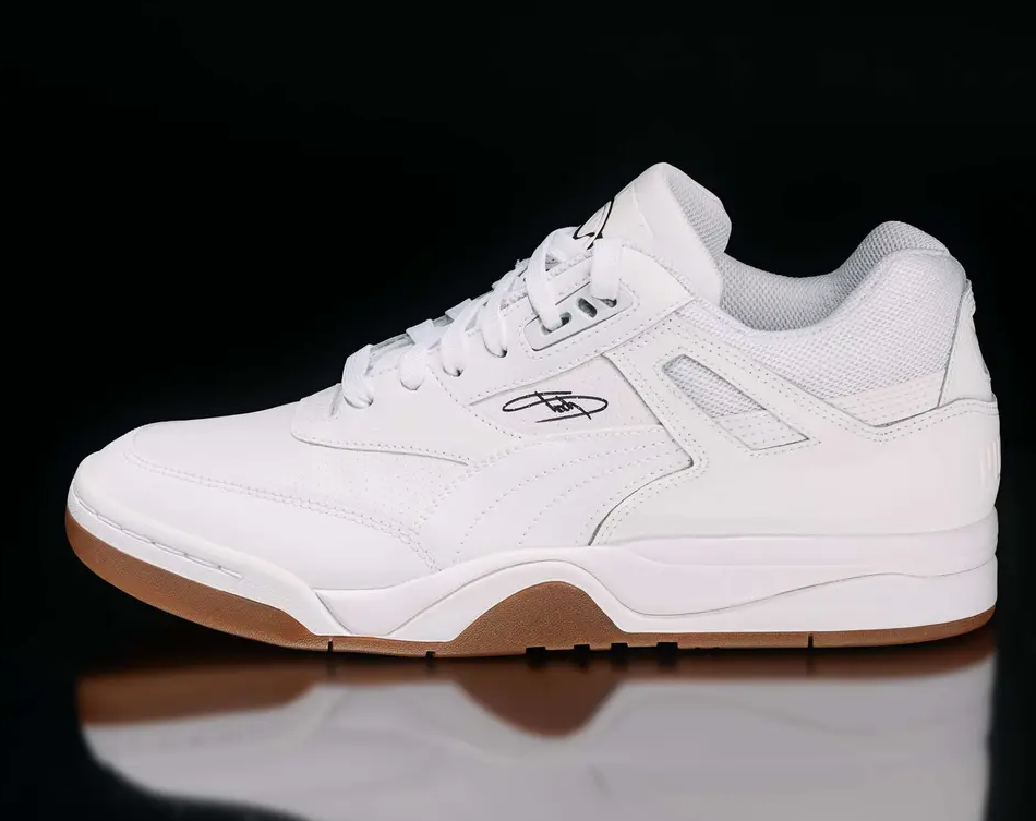 White athletic shoes with black accents and a gum sole